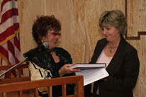 Judy Chicago presenting The Dinner Party Book to NM Lt. Governor Diane Denish